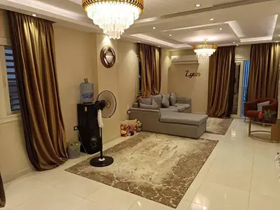 a large living room with a couch and a fan at بليله هاوس in Balīlā