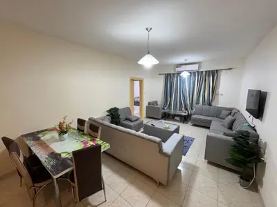 a living room with a couch and a table at Al-Amer شقق الخامسه الراقيه in Aqaba