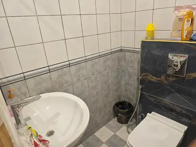 a bathroom with a white toilet and a sink at شقة 3غرف نوم في ضاحية الرشيد in Amman