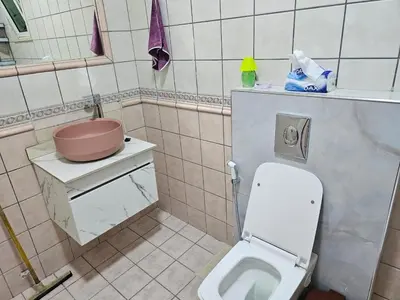 a small bathroom with a toilet and a sink at شقة 3غرف نوم في ضاحية الرشيد in Amman
