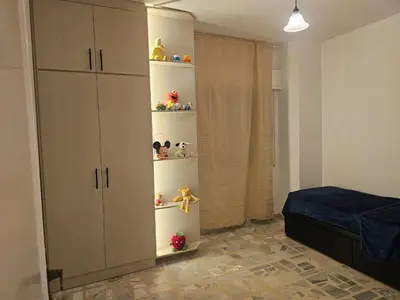 a bedroom with a bed and a closet with shelves at شقة 3غرف نوم في ضاحية الرشيد in Amman