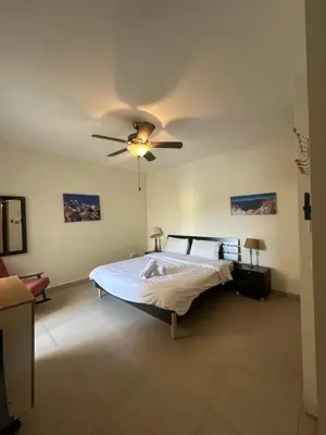 a bedroom with a bed and a ceiling fan at arabian gulf in Al Burj