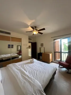 a bedroom with a large bed with a ceiling fan at arabian gulf in Al Burj