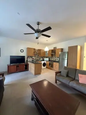 a living room with a couch and a ceiling fan at arabian gulf in Al Burj