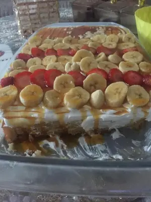 a cake with bananas and cherries on top of it at الريف فيلا in Ar Ramthā
