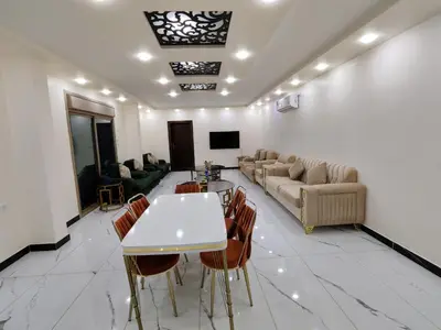 a living room with a couch and a table and chairs at Wonder Villa in Al Rama