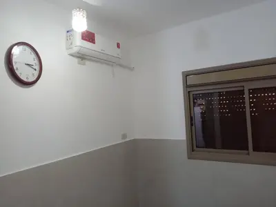 a clock on a wall next to a window at Sky 2 in Jerash