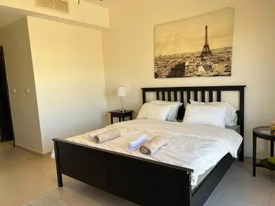 a bedroom with a bed with two towels on it at Abdoun is comfortable accommodation and an exceptional location close to the mall in Amman