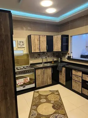 a kitchen with a sink and a tv in it at ranos villa in An Nu‘ayyimah