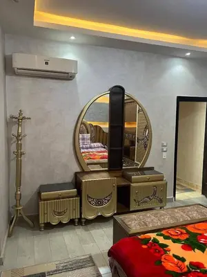 a dressing room with a mirror and a dressing table at ranos villa in An Nu‘ayyimah