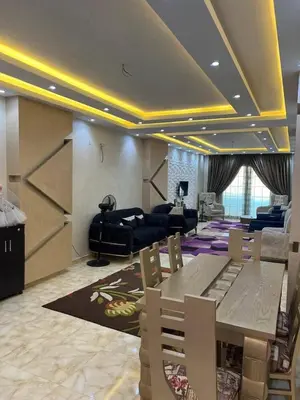 a large living room with a table and a couch at ranos villa in An Nu‘ayyimah