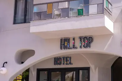 a building with a sign on the side of it at Hill Top Hotel in Aqaba