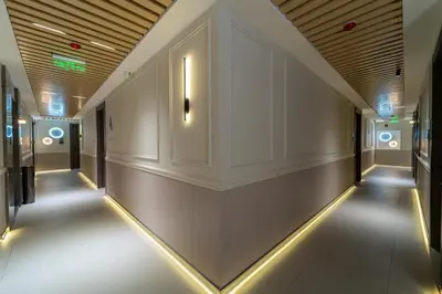 a hallway of a building with lights on the walls at Hill Top Hotel in Aqaba