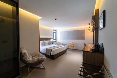 a hotel room with a bed and a chair at Hill Top Hotel in Aqaba