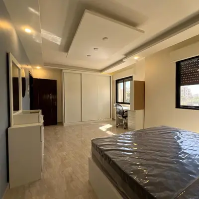 a large room with a bed and a kitchen at اربد in Irbid