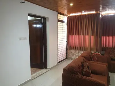 a living room with a couch and a glass door at الاردن عمان تلاع العلي شارع ابو يوسف الأنصاري اسكان طارق الشيخ in Amman