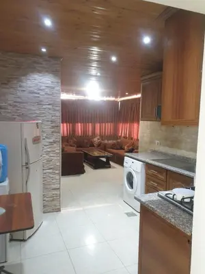 a kitchen with a living room with a couch at الاردن عمان تلاع العلي شارع ابو يوسف الأنصاري اسكان طارق الشيخ in Amman