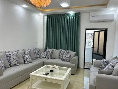 a living room with a couch and a coffee table at Raha's house in Jerash