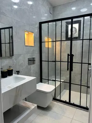a bathroom with a toilet and a sink and a shower at Raha's house in Jerash