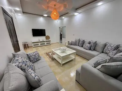 a living room with a couch and a table at Raha's house in Jerash