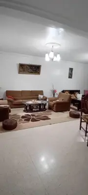 a living room with couches and a table at النعيمه هاوس in An Nu‘ayyimah