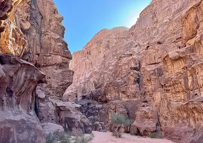 a canyon with a rocky mountain with a dirt road at Rum Sky Experiences in Wadi Rum
