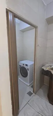 a washer and dryer in a small bathroom at الريان غرفتين نوم in Amman