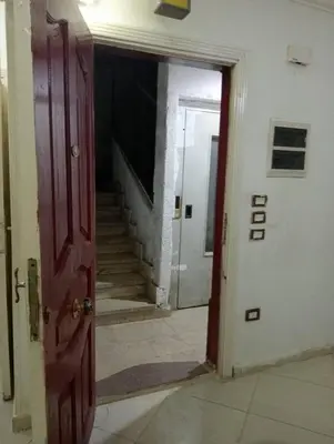 an open door to a hallway with a staircase at ام الدنانير هاوس in Rujm al Ḩāwī