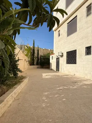 an empty street in front of a building at Warm 1BR in Dabouq in Amman