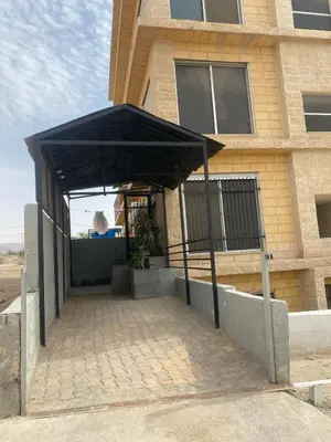 a black canopy in front of a building at beautiful apartment in the DeadSea in Sowayma