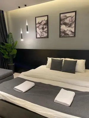 a bedroom with a large bed with two towels on it at beautiful apartment in the DeadSea in Sowayma