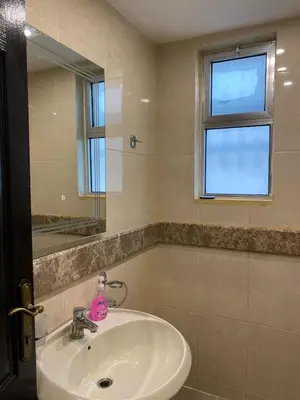 a bathroom with a sink and a mirror at beautiful apartment in the DeadSea in Sowayma