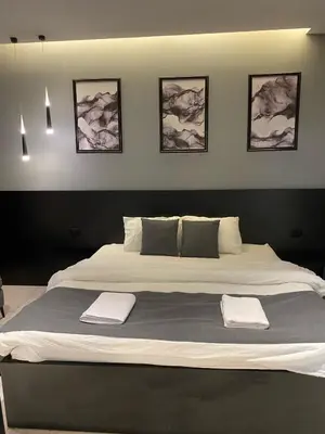 a large bed with two towels on top of it at beautiful apartment in the DeadSea in Sowayma