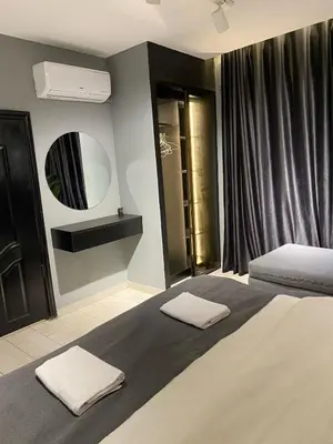 a bedroom with a bed with two towels on it at beautiful apartment in the DeadSea in Sowayma
