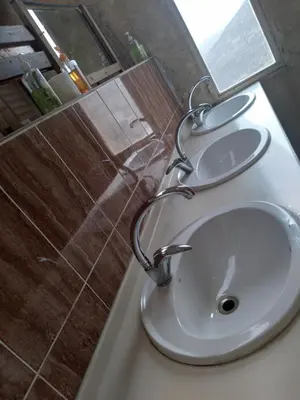 a white sink in a bathroom with a shower at Dana Village lodge and Camp-Wadi Dana Eco camp in Dana
