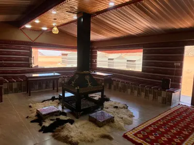 a room with a stove in the middle of a room at Wadi Rum Camp and Tours in Wadi Rum