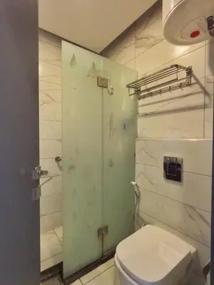 a bathroom with a toilet and a shower at Holiday Season Hotel in Aqaba