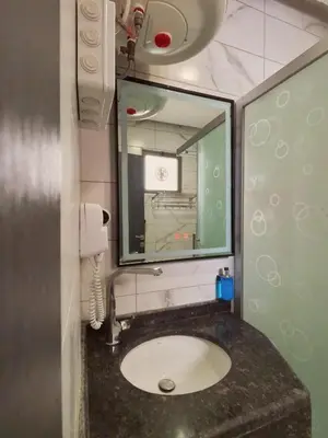 a bathroom with a sink and a mirror at Holiday Season Hotel in Aqaba