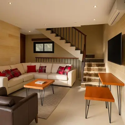 a living room with a couch and a tv at Jordan Castle Resort in Irbid