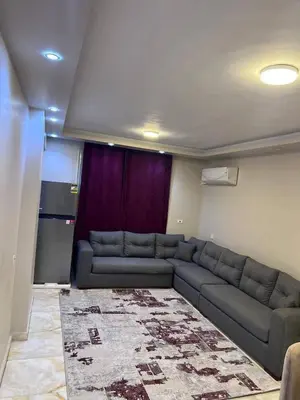 a living room with a couch and a kitchen at الاغوار bb in Khirbat ash Shaykh Muḩammad