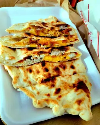 a stack of three pancakes on a white plate at الاغوار bb in Khirbat ash Shaykh Muḩammad