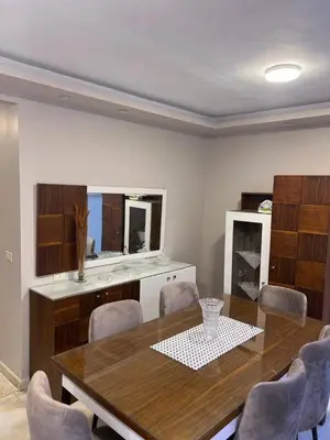 a dining room with a wooden table and chairs at الاغوار bb in Khirbat ash Shaykh Muḩammad