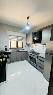 a large kitchen with a stove top oven at شقق فاخره للايجار in Amman