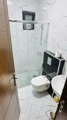 a bathroom with a shower and a toilet and a sink at شقق فاخره للايجار in Amman