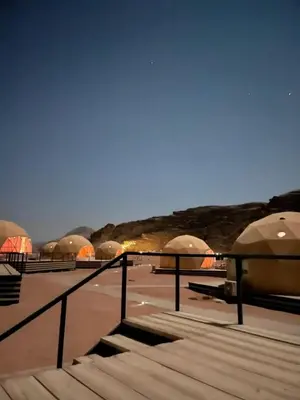 a row of domes with tents in the background at Kadi Wadi Rum in Al Jafr