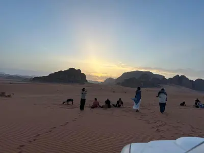 a group of people walking in the desert at Kadi Wadi Rum in Al Jafr