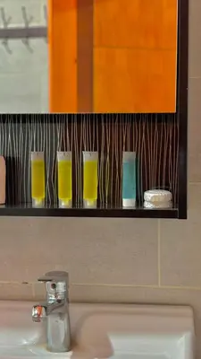 a shelf above a sink with four glasses on it at wadi rum luxury bubble soul in Wadi Rum