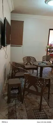 a living room with a table and chairs and a tv at المنشيه هاوس in Maţār al Malik Ḩusayn