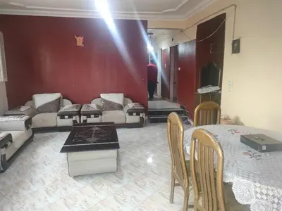 a living room with a couch and a table at المنشيه هاوس in Maţār al Malik Ḩusayn