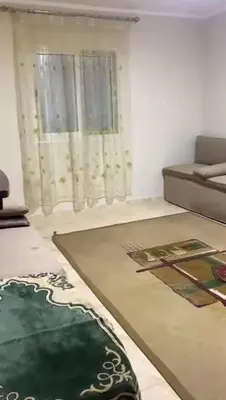 a living room with a couch and a rug at مليح هوستل